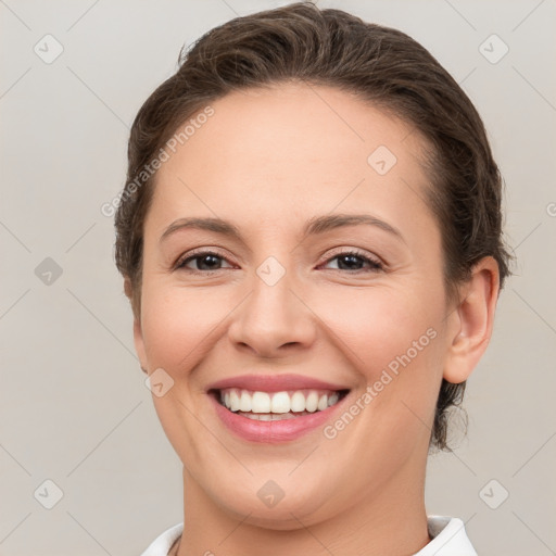 Joyful white young-adult female with short  brown hair and brown eyes