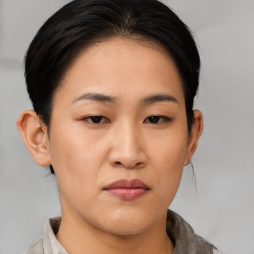 Joyful asian young-adult female with medium  brown hair and brown eyes