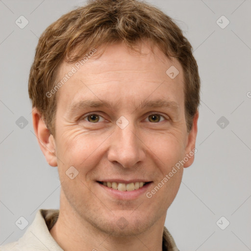 Joyful white adult male with short  brown hair and grey eyes