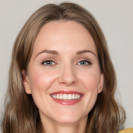 Joyful white young-adult female with long  brown hair and grey eyes