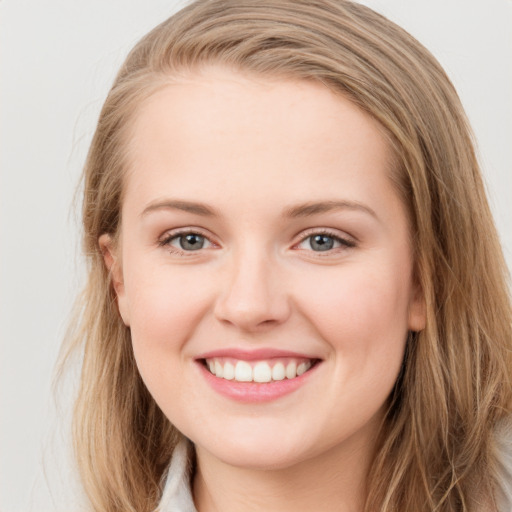 Joyful white young-adult female with long  brown hair and grey eyes