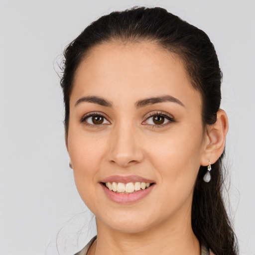 Joyful latino young-adult female with long  brown hair and brown eyes