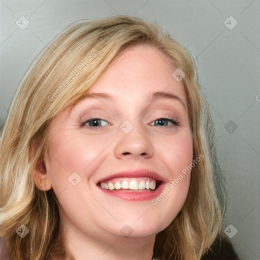 Joyful white young-adult female with long  brown hair and blue eyes