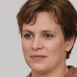 Joyful white adult female with medium  brown hair and grey eyes