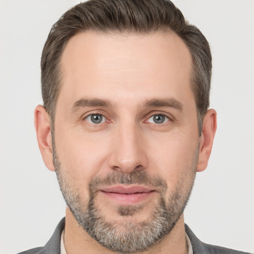 Joyful white adult male with short  brown hair and brown eyes