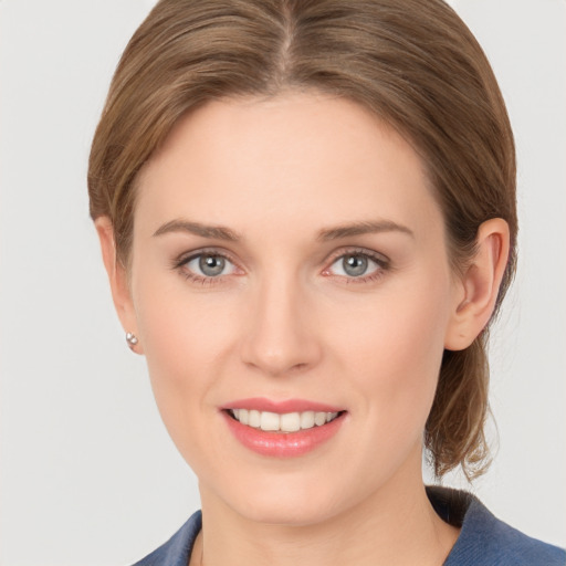 Joyful white young-adult female with medium  brown hair and grey eyes