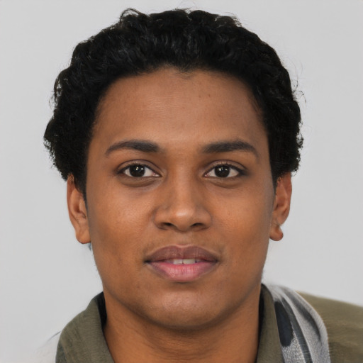Joyful black young-adult female with short  black hair and brown eyes