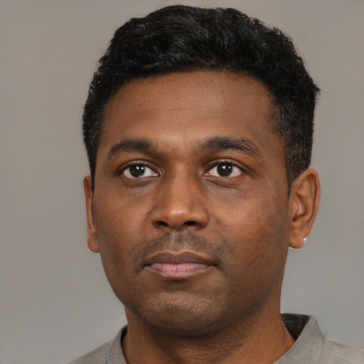 Neutral black young-adult male with short  black hair and brown eyes