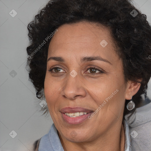 Joyful black adult female with medium  brown hair and brown eyes