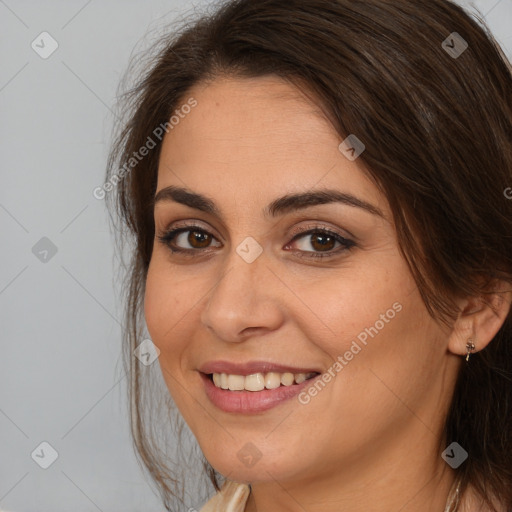 Joyful white young-adult female with long  brown hair and brown eyes