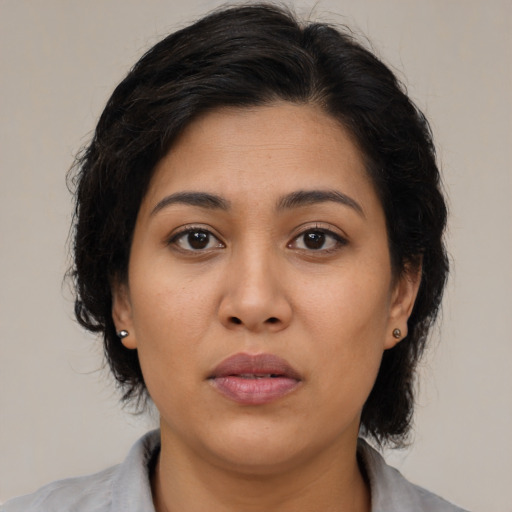 Neutral latino young-adult female with medium  brown hair and brown eyes