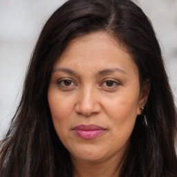 Joyful white adult female with long  brown hair and brown eyes