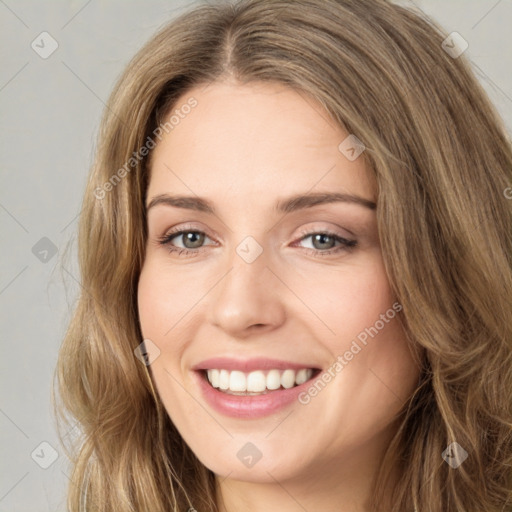 Joyful white young-adult female with long  brown hair and green eyes