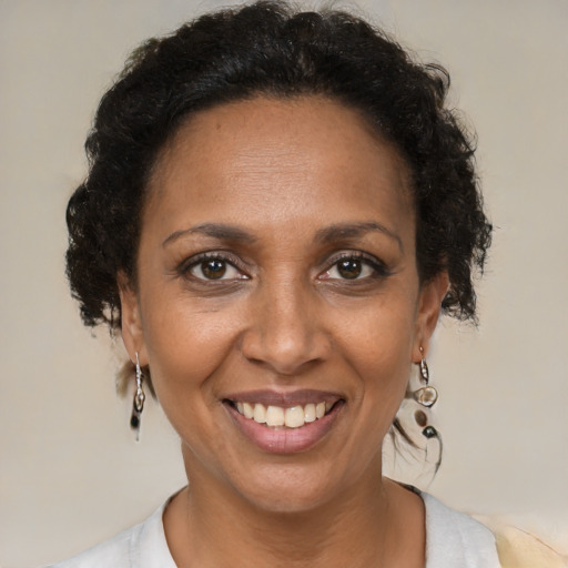 Joyful black adult female with medium  brown hair and brown eyes