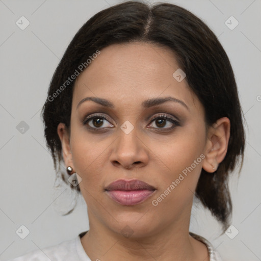 Joyful latino young-adult female with medium  brown hair and brown eyes