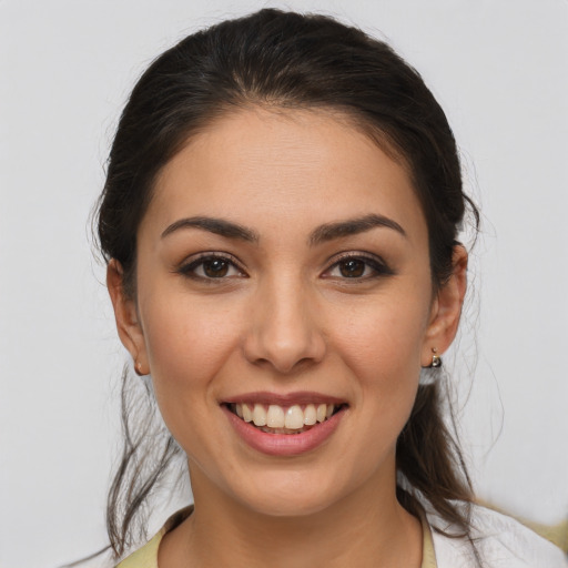 Joyful white young-adult female with medium  brown hair and brown eyes