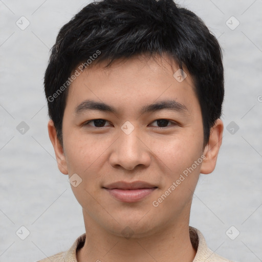 Joyful asian young-adult male with short  brown hair and brown eyes