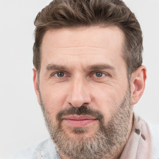 Joyful white adult male with short  brown hair and grey eyes