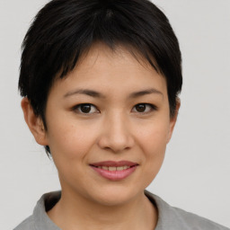 Joyful asian young-adult female with short  brown hair and brown eyes