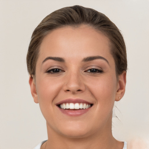 Joyful white young-adult female with short  brown hair and brown eyes