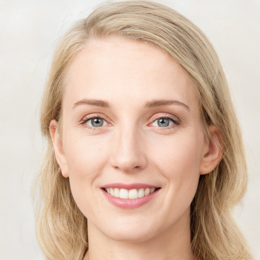 Joyful white young-adult female with long  brown hair and blue eyes