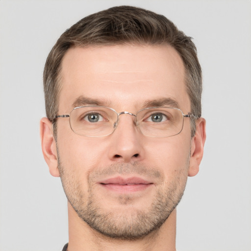 Joyful white adult male with short  brown hair and grey eyes