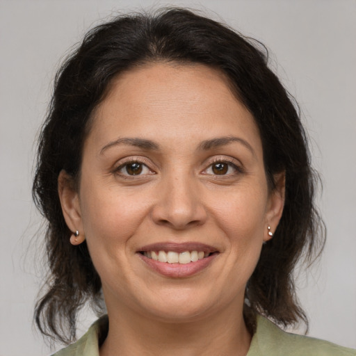 Joyful white adult female with medium  brown hair and brown eyes