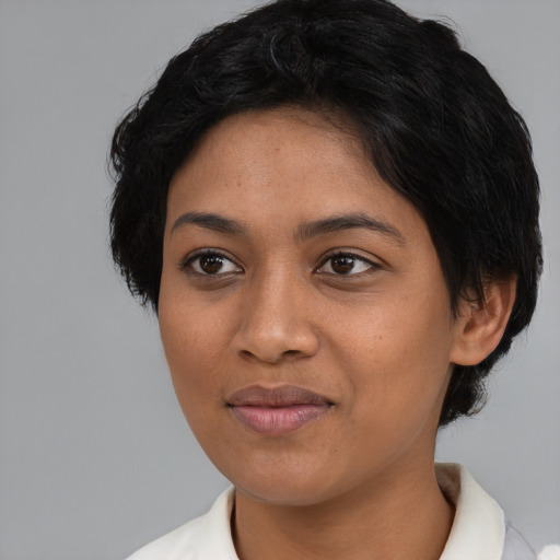 Joyful latino young-adult female with short  black hair and brown eyes
