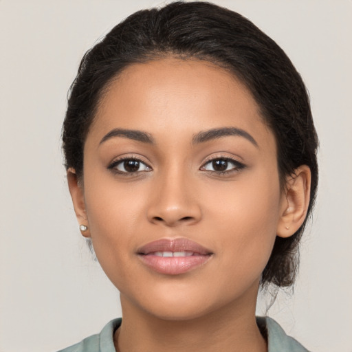 Joyful latino young-adult female with long  black hair and brown eyes