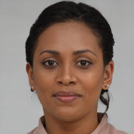 Joyful black young-adult female with short  brown hair and brown eyes
