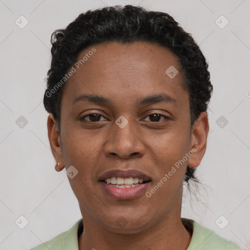 Joyful black young-adult female with short  black hair and brown eyes