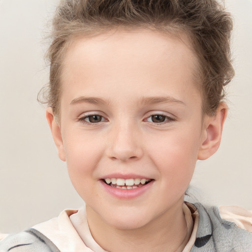 Joyful white child female with short  brown hair and brown eyes