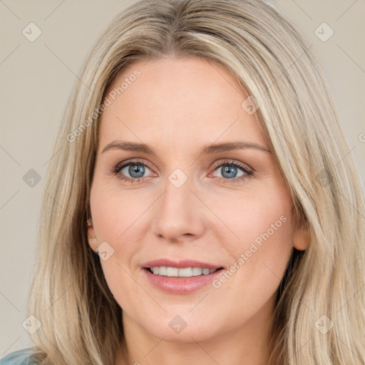 Joyful white young-adult female with long  brown hair and blue eyes