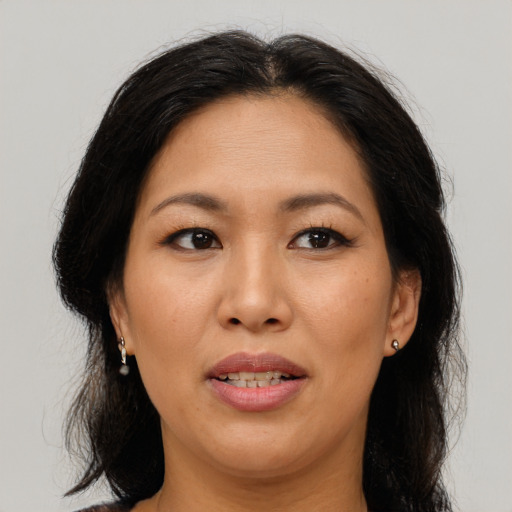 Joyful asian adult female with long  brown hair and brown eyes