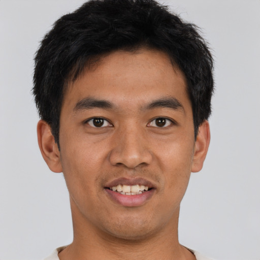 Joyful asian young-adult male with short  black hair and brown eyes