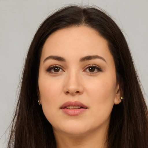 Joyful white young-adult female with long  brown hair and brown eyes