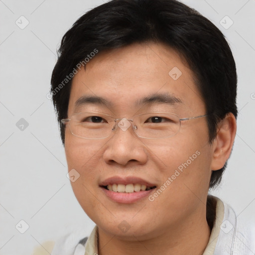 Joyful asian young-adult male with short  brown hair and brown eyes