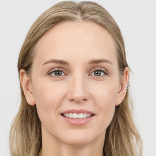 Joyful white young-adult female with long  brown hair and blue eyes