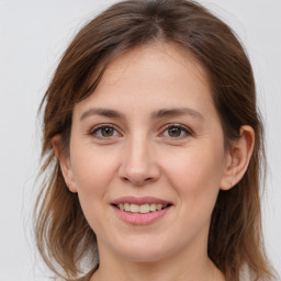 Joyful white young-adult female with medium  brown hair and grey eyes