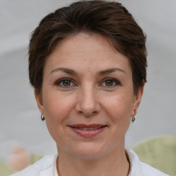 Joyful white adult female with short  brown hair and brown eyes