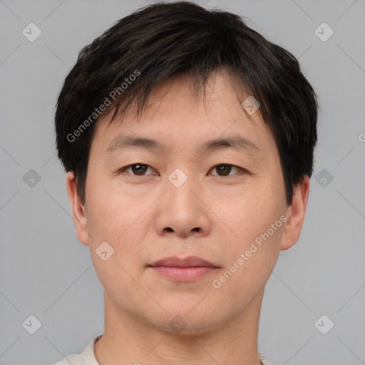 Joyful asian young-adult male with short  brown hair and brown eyes