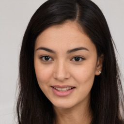 Joyful asian young-adult female with long  brown hair and brown eyes