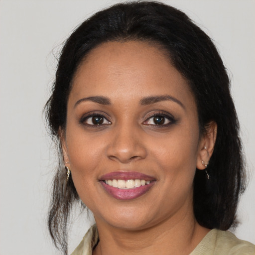 Joyful black young-adult female with medium  brown hair and brown eyes