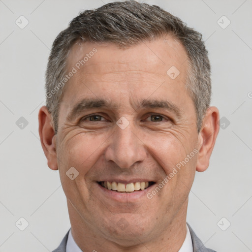 Joyful white adult male with short  brown hair and brown eyes