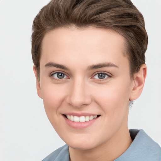 Joyful white young-adult female with short  brown hair and grey eyes