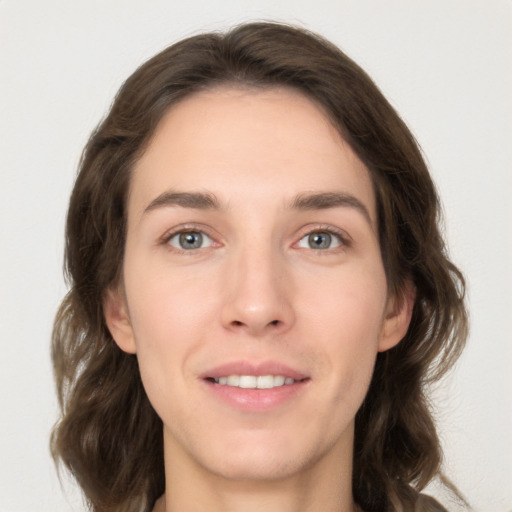 Joyful white young-adult female with long  brown hair and grey eyes