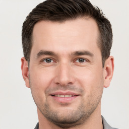 Joyful white young-adult male with short  brown hair and brown eyes