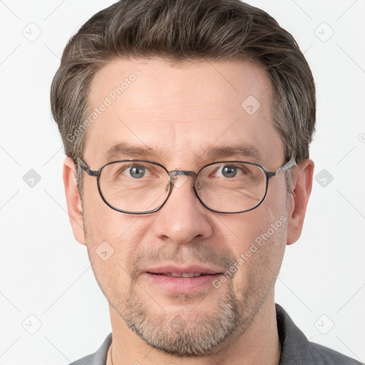 Joyful white adult male with short  brown hair and grey eyes