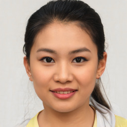 Joyful asian young-adult female with medium  brown hair and brown eyes