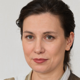 Joyful white adult female with medium  brown hair and brown eyes